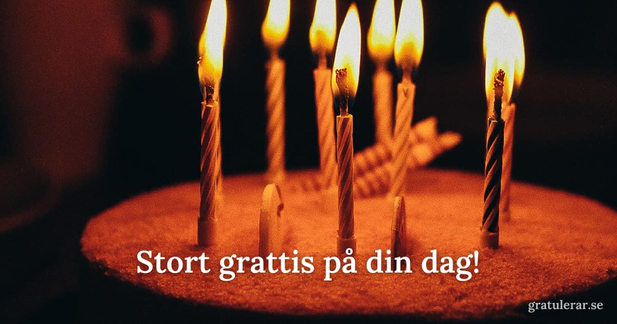 Tårta med tända ljus mot mörk bakgrund — stämningsfullt födelsedagskort